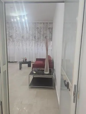 a living room with a red couch and a table at SWEET HOME Porta Maggiore in Rome