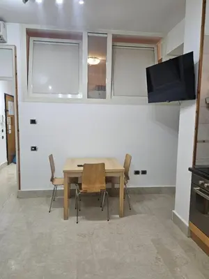 a dining room with a wooden table and chairs at SWEET HOME Porta Maggiore in Rome
