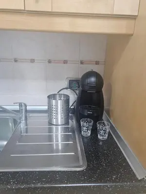 a kitchen counter with a sink and a coffee maker at SWEET HOME Porta Maggiore in Rome