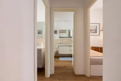 a bedroom with a bed and a sink and a mirror at Clio Rome Suite 2 bedroom 2 bathroom apartment in Rome