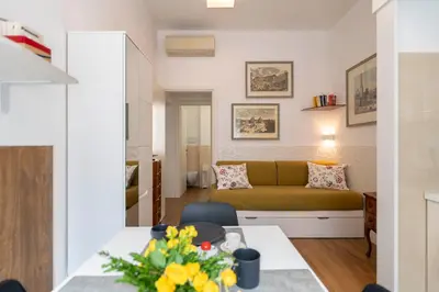 a living room with a couch and a table at Clio Rome Suite 2 bedroom 2 bathroom apartment in Rome