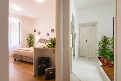 a bedroom with a bed and plants in it at Clio Rome Suite 2 bedroom 2 bathroom apartment in Rome