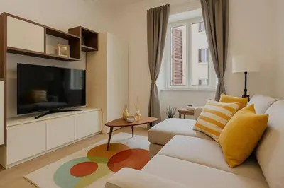 a living room with a couch and a flat screen tv at Tiepolo La Vie Apartment - Rome Flaminio in Rome