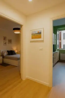 a living room with a couch and a bed at Tiepolo La Vie Apartment - Rome Flaminio in Rome
