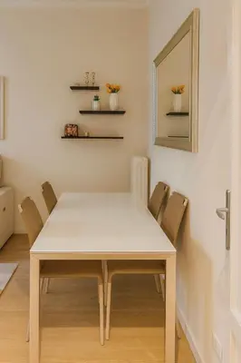 a white dining room table with chairs and a mirror at Tiepolo La Vie Apartment - Rome Flaminio in Rome