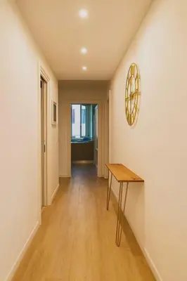 a hallway with a table and a mirror on a wall at Tiepolo La Vie Apartment - Rome Flaminio in Rome