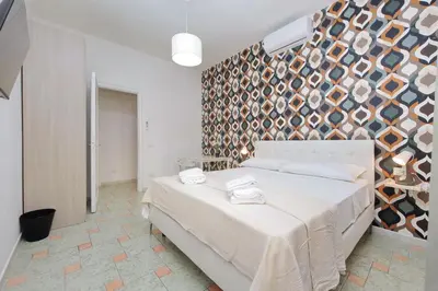 a bedroom with a bed and a wall with plates at Domus Sinuessa in Rome