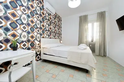 a bedroom with a bed and a wall at Domus Sinuessa in Rome