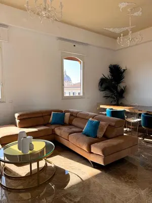 a living room with a brown couch and a table at MarbleApartment in Rome