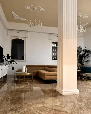 a living room with a couch and a column at MarbleApartment in Rome