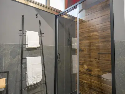 a glass shower stall with a toilet in a bathroom at Relax e Style, Kairos, the house of quality time in Rome