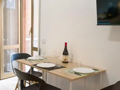 a table with glasses and a bottle of wine on it at Relax e Style, Kairos, the house of quality time in Rome