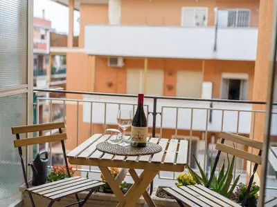 a bottle of wine sitting on a table on a balcony at Relax e Style, Kairos, the house of quality time in Rome