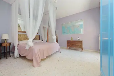a bedroom with a canopy bed and a wooden dresser at Pascarella - Trastevere in Rome