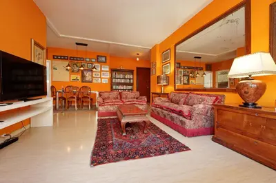 a living room with two couches and a flat screen tv at Pascarella - Trastevere in Rome