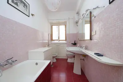 a bathroom with a tub and a sink and a toilet at Pascarella - Trastevere in Rome