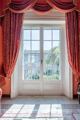 a room with a large window with red curtains at Residenza Episcopo Lipinsky 1902 in Rome