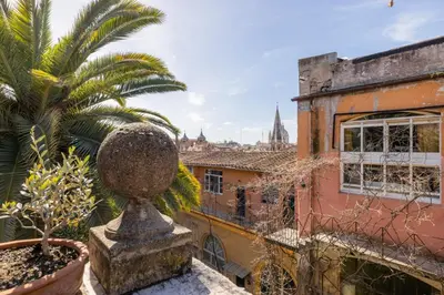 a view of an old building and a palm tree at Residenza Episcopo Lipinsky 1902 in Rome