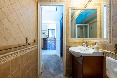 a bathroom with a sink and a mirror at Residenza Episcopo Lipinsky 1902 in Rome