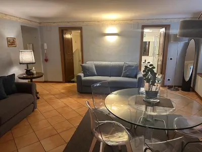 a living room with a glass table and a couch at Apt Aurea Domus al Pantheon in Rome