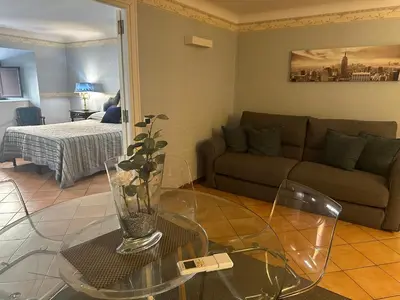 a living room with a couch and a glass table at Apt Aurea Domus al Pantheon in Rome