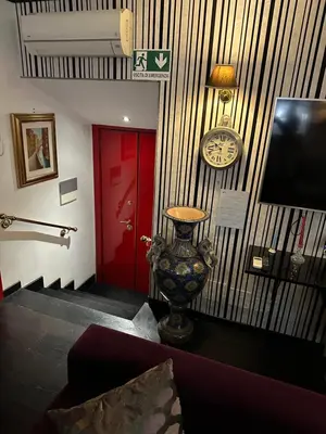 a room with a clock and a vase on a wall at Apt Aurea Luxury Pantheon View in Rome