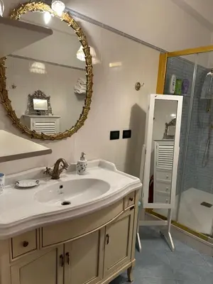 a bathroom with a sink and a mirror and a shower at Apt Aurea Luxury Pantheon View in Rome
