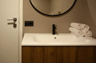 a bathroom with a white sink and a mirror at Pantheon-Rondanini - Cozy Apartment in Rome