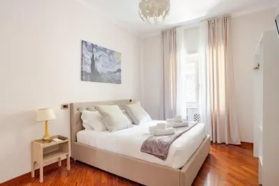 a bedroom with a large white bed with white pillows at Family House 10 Min Metro Conca d'Oro in Rome