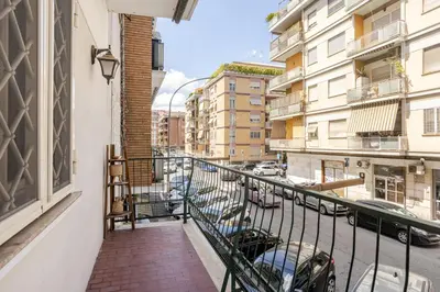 a balcony of a building with cars parked on a street at Family House 10 Min Metro Conca d'Oro in Rome