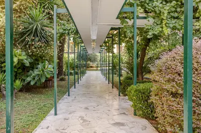 a walkway in a greenhouse with plants at Family House 10 Min Metro Conca d'Oro in Rome