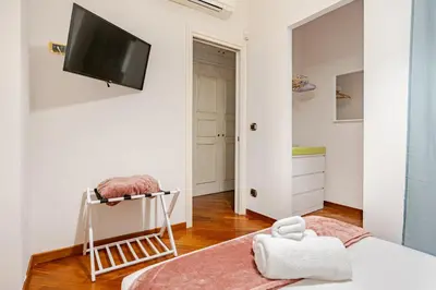 a bedroom with a flat screen tv on a wall at Family House 10 Min Metro Conca d'Oro in Rome