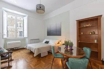 a living room with a bed and a table at Maison Haysée Piazza del Popolo in Rome