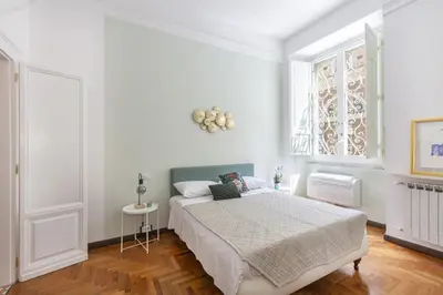 a white bedroom with a bed and a window at Maison Haysée Piazza del Popolo in Rome
