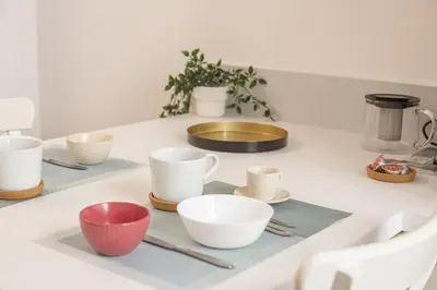 a white counter with bowls and cups on it at Maison Haysée Piazza del Popolo in Rome