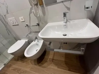 a white bathroom with a sink and a toilet at MARITZA Guest House 2 in Rome