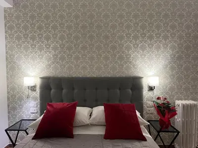 a bedroom with a large bed with red pillows at MARITZA Guest House 2 in Rome