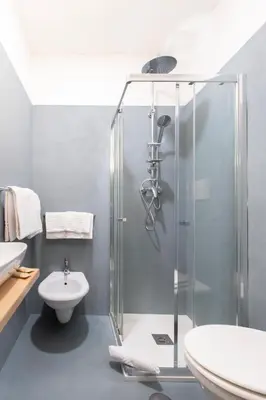 a bathroom with a shower and a toilet and a sink at Piccolo Imperiale in Rome