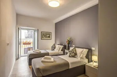 a bedroom with two beds and a window at Orange Suites in Rome