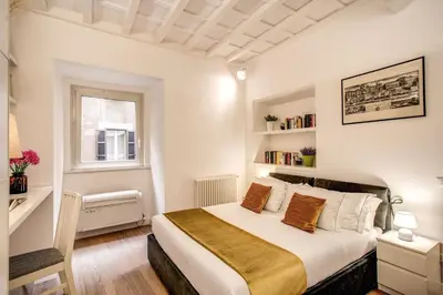 a bedroom with a bed and a window at Orange Suites in Rome