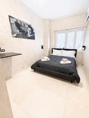 a large white bed with towels on top of it at Appio Rooms Haven in Rome