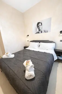 a bedroom with two beds and a painting on the wall at Appio Rooms Haven in Rome