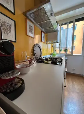 a kitchen with a white counter top and a sink at GeNa Home, a due passi da San Giovanni in Rome