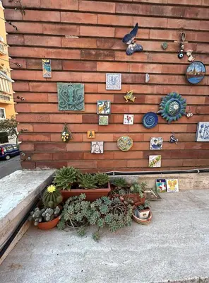 a wooden wall with plants and decorations on it at GeNa Home, a due passi da San Giovanni in Rome