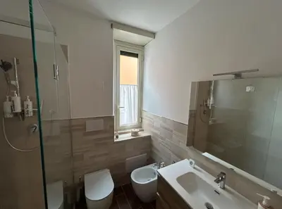 a bathroom with two toilets and a sink and a shower at GeNa Home, a due passi da San Giovanni in Rome