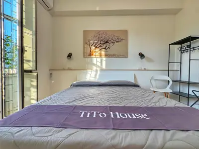 a bedroom with a bed with a sqor house sign on it at Tito House in Rome