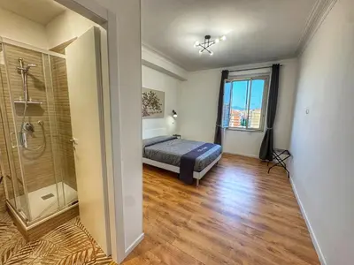 a bedroom with a bed and a walk in shower at Tito House in Rome