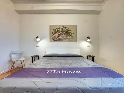 a bedroom with a bed with a sqor house sign on it at Tito House in Rome