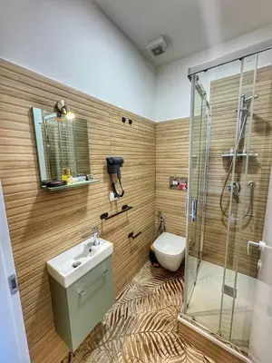 a bathroom with a shower and a sink and a toilet at Tito House in Rome