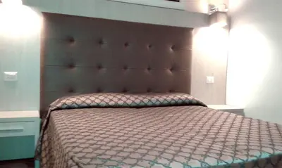 a bedroom with a large bed with a large headboard at IL Sole in Rome